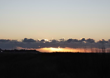 Sunset Over Grassy Field