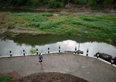 Runner on Bridge Over River