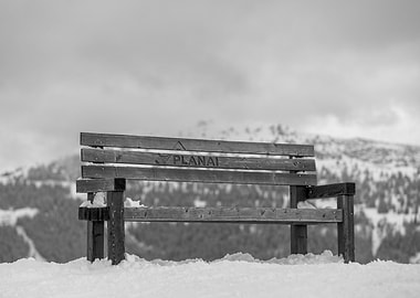 Wooden Bench in Snowy Mountains