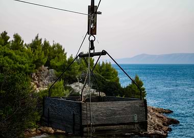 Wooden Crate Suspended Over Sea