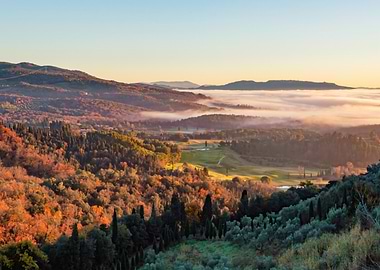 Tuscany countryside rolling hills at sunrise with fog covering the valley