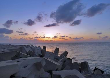 Sunset Over Concrete Breakwater