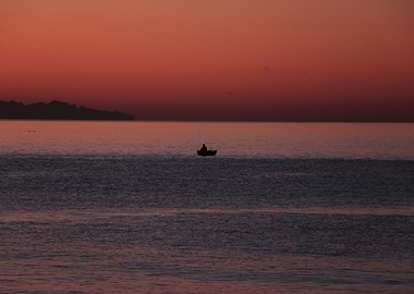 Silhouette of a Boat before Sunrise