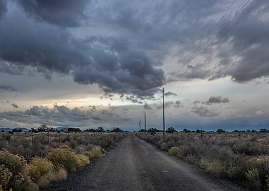 Dusty Road Under Stormy Sky