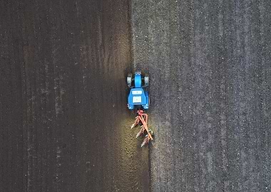 New Holland Tractor Plowing Field