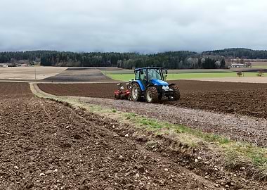New Holland Tractor Plowing Field