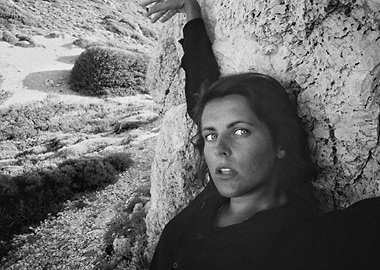 Woman Leaning Against Rock