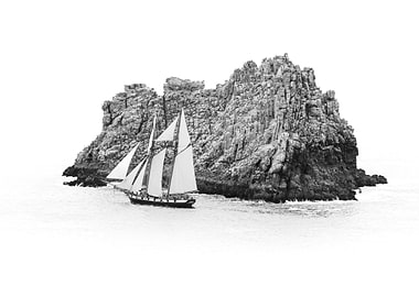 Sailboat by Rocky Coast