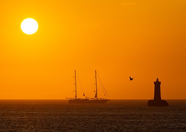 Sunset Sailboat and Lighthouse