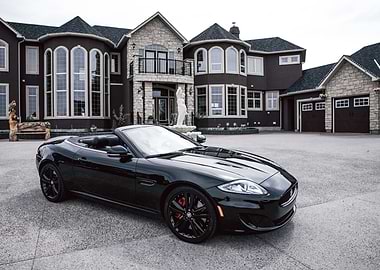 Black Convertible Jaguar in Front of Mansion