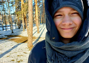 Smiling Boy in Winter Forest