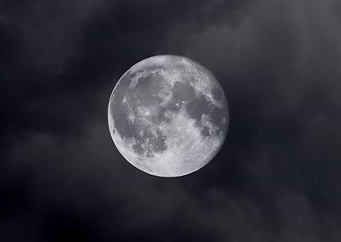 Full Moon in Cloudy Night Sky