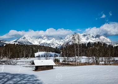 Winter landscape with cabin and mountains