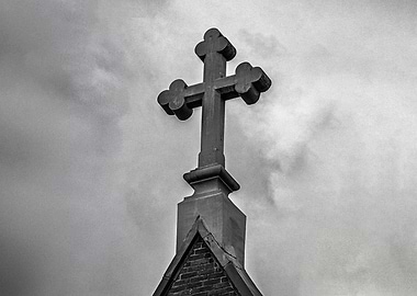 Stone Cross Against Cloudy Sky