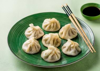 Dumplings on Green Plate with Chopsticks