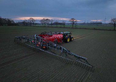Tractor spreading slurry in a field