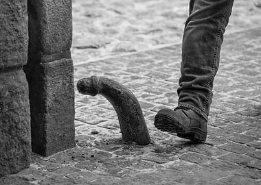 Foot about to step on metal hook