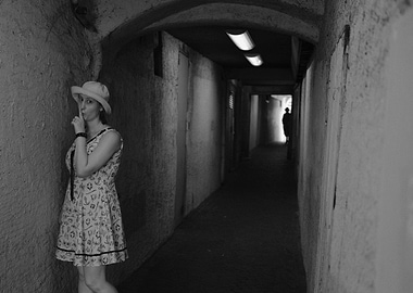 Woman in alleyway, finger to lips