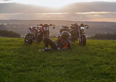 Motorcycle Rider Relaxing on Grassy Hill