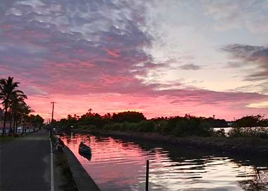 Pink Sunset over Canal with Boat
