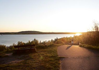 Sunset over lake with bench