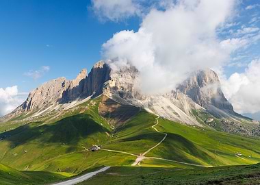 Sosslungo mountain peak with clouds and green valley
