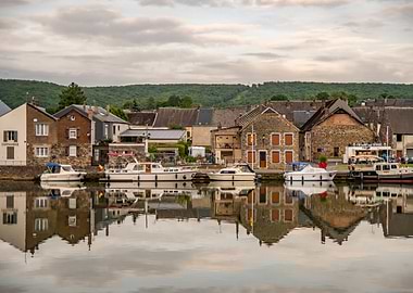 Riverfront Town with Boat Reflections