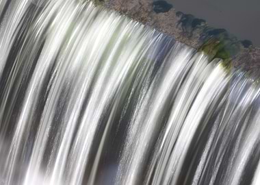 Water cascading over a small dam