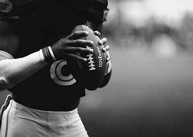 Football Player Holding Wilson Football