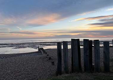 Beach Sunset with Wooden Posts