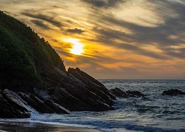 Coastal Sunset with Rocks and Vegetation