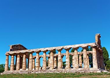 Ancient Greek Temple Ruins Under Blue Sky in Paestum, Italy