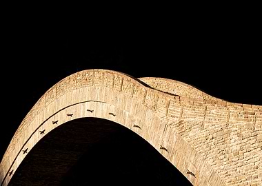 Stone Bridge Arch Against Black Background