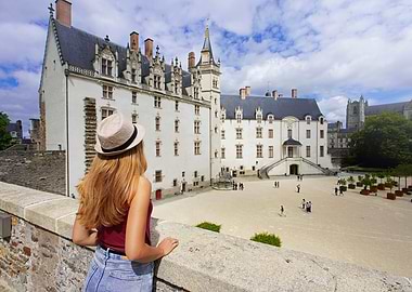 Woman overlooking Château des Ducs de Bretagne, Nantes, France