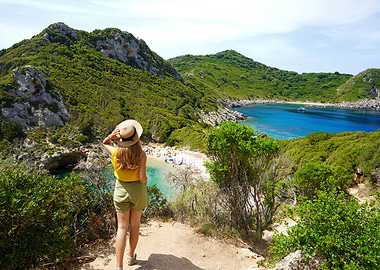 Woman overlooking beautiful bay of Porto Timoni, Corfu Island, Greece