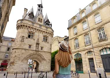 Woman admiring Porte Cailhau, Bordeaux, France