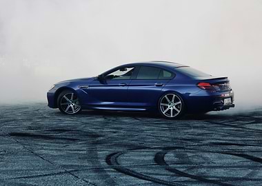 Blue BMW drifting in smoke