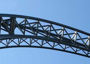 Rollercoaster track against blue sky