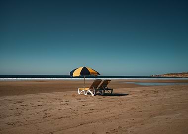 Beach scene with umbrella and chairs