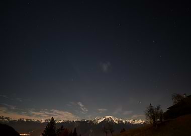 Night Sky Over Snowy Mountains