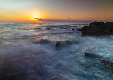Ocean Sunset with Rocks and Waves
