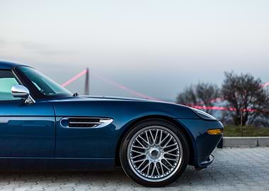 Blue Car with Bridge in Background