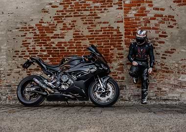 Motorcycle and Rider Against Brick Wall