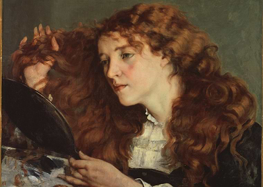 Red-haired woman looking in a mirror
