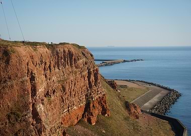 Heligoland Cliffside View - ship at the horizon