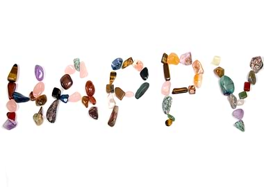 Happy word made of colorful stones
