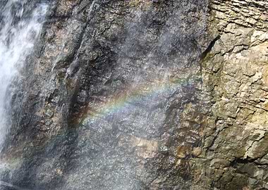 Waterfall Rainbow on Rocky Cliff