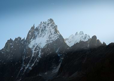 Snow-Capped Mountain Peaks Against Blue Sky