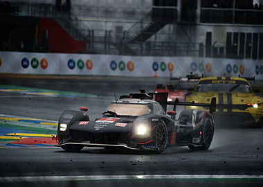 Racing cars on a wet track