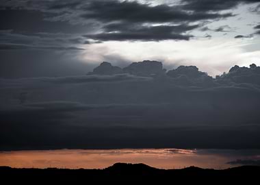Dramatic Clouds Over Silhouette Landscape